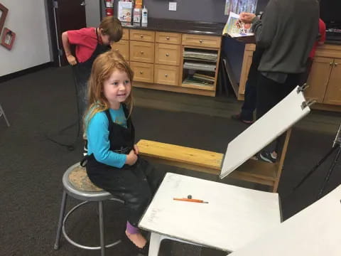 a girl sitting at a desk