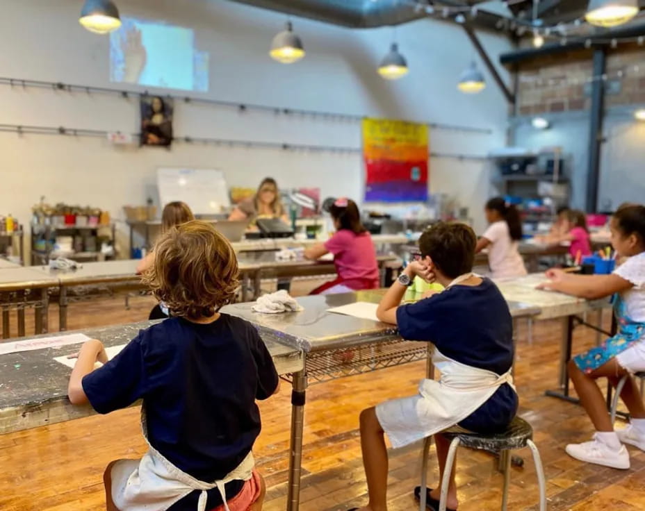 a group of children sitting at desks in a classroom