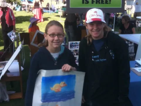 a couple of women holding a picture