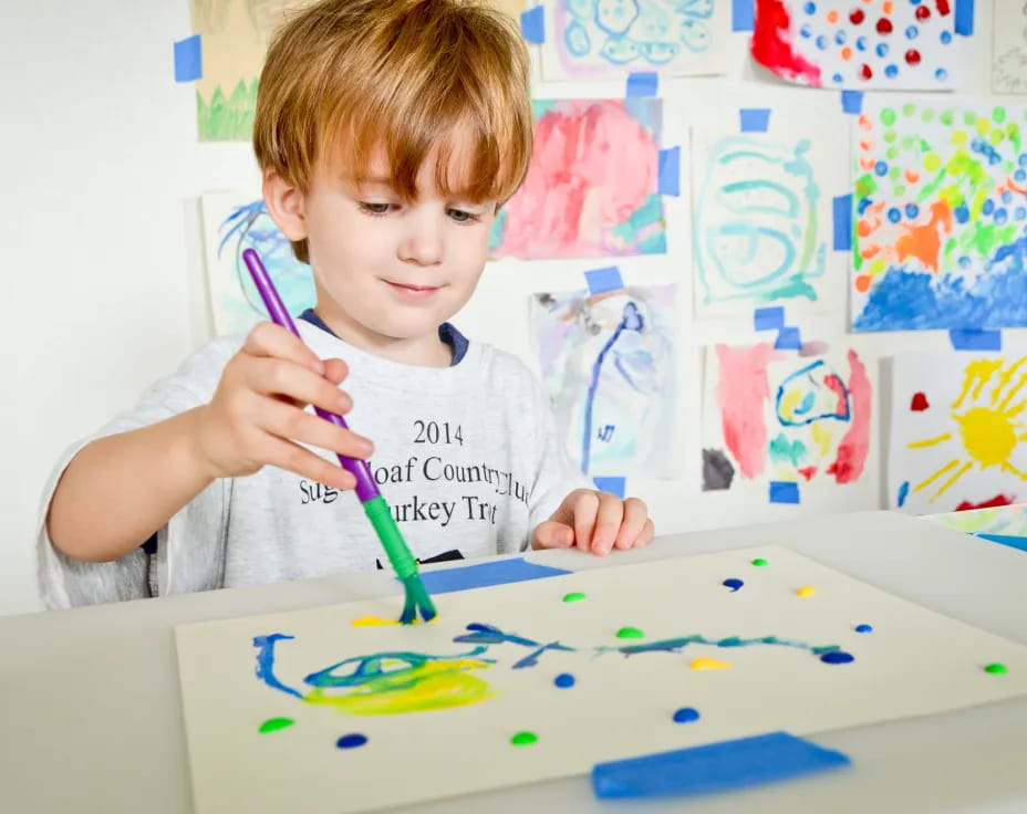 a child painting on a table