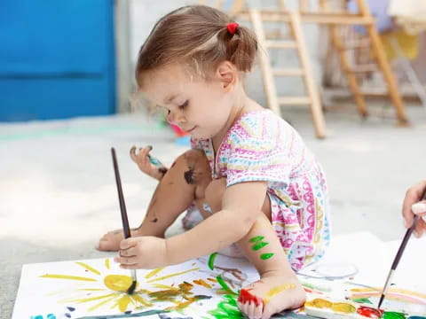 a girl painting with a brush