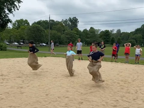 a group of people playing in the sand