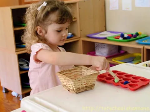 a little girl cutting a cake