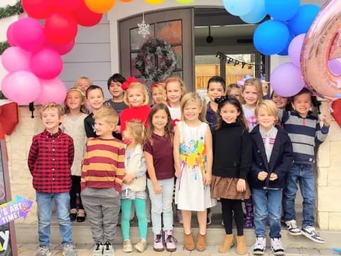 a group of people posing for a photo with balloons