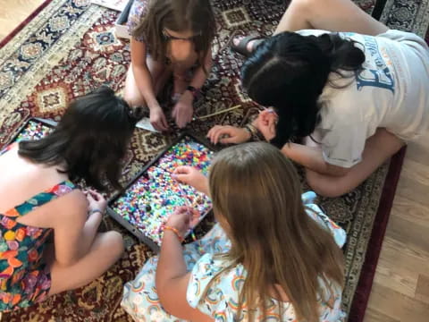 a group of children playing on a rug