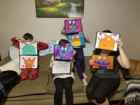 a group of children holding up colorful paper bags