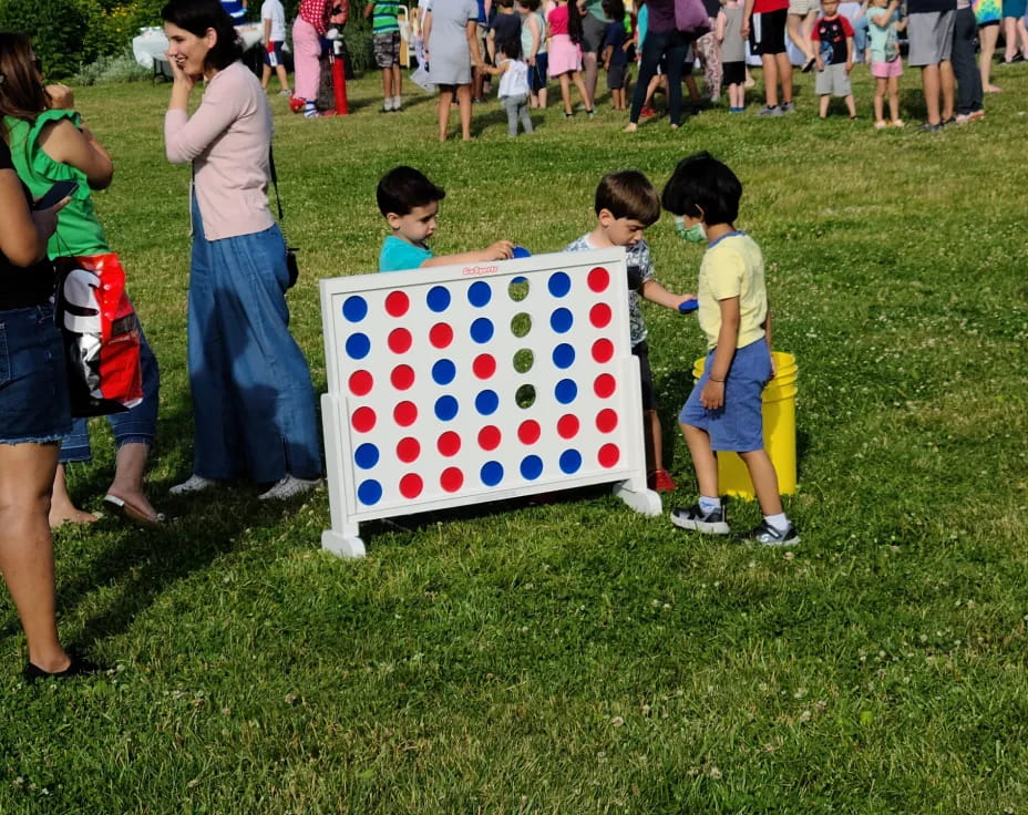 a group of children standing around a flag