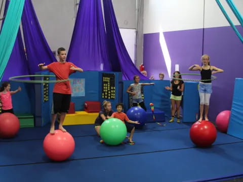a group of people on a stage with balls