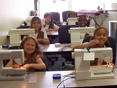 a group of people sitting at desks in a room