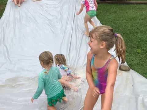 a group of children playing in a pool
