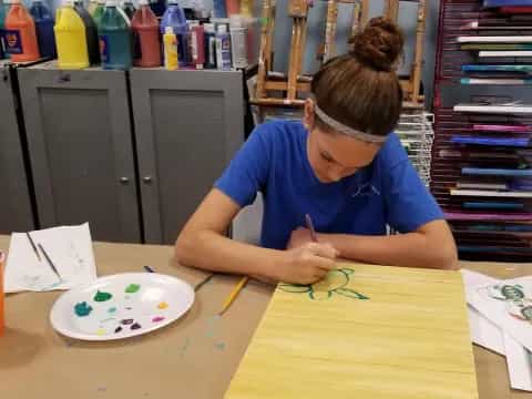 a person painting on a table
