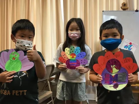 a group of kids holding up toys