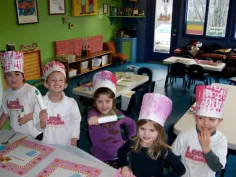 a group of children wearing party hats