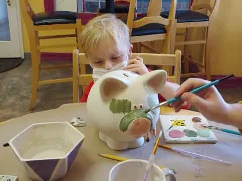 a child painting on a table