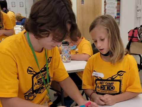 a few young girls in yellow t-shirts