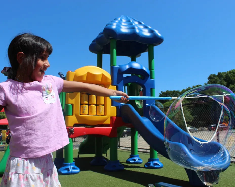 a girl playing with a toy