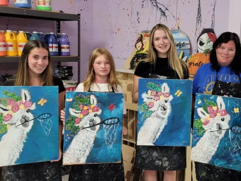 a group of girls holding up drawings