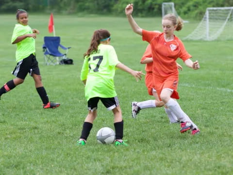 girls playing football on a field