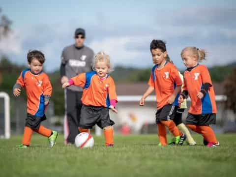 a group of kids playing football