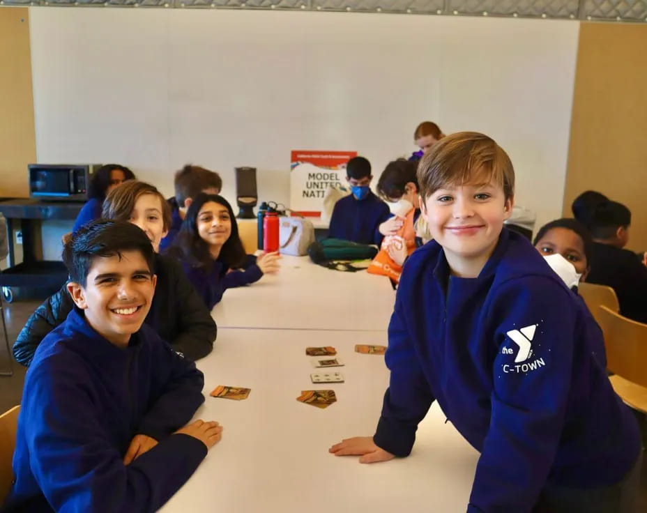 a group of children sitting at a table