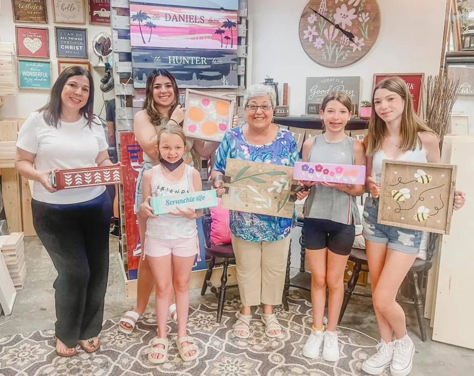 a group of women holding boxes