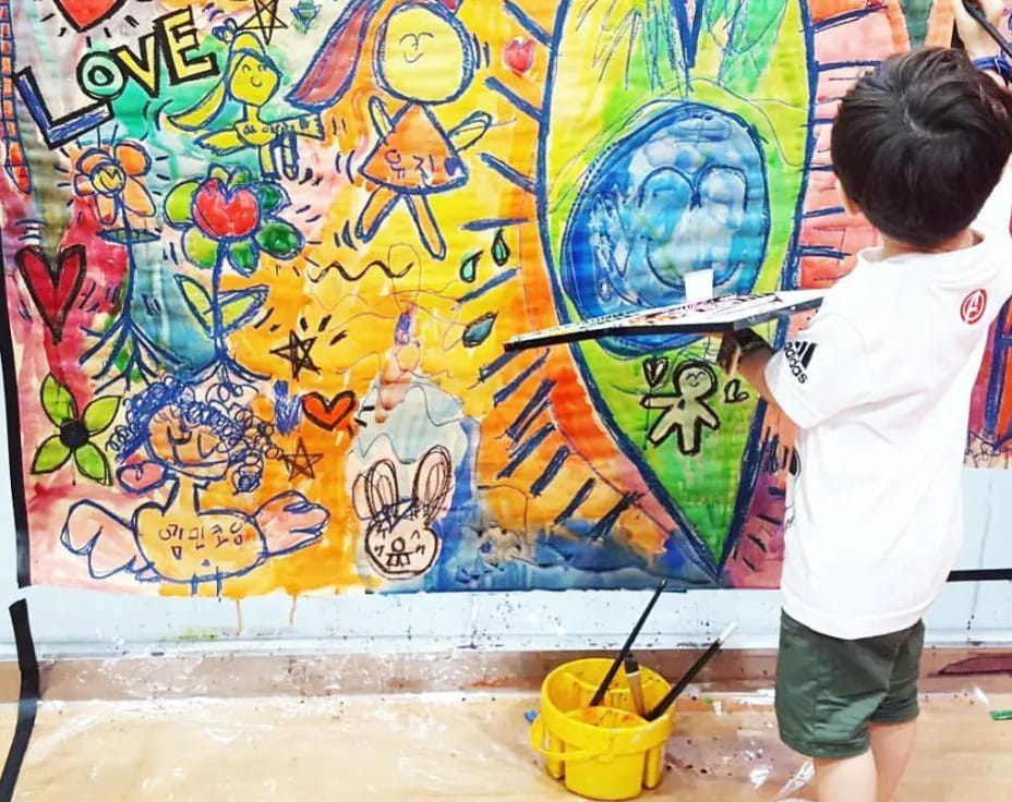 a child painting a mural