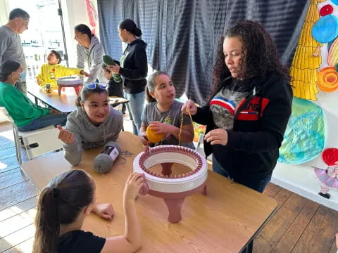 a group of people sitting around a table with food