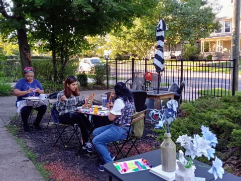 a group of people sitting at a table outside