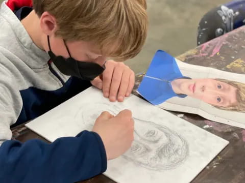 a boy painting on a table