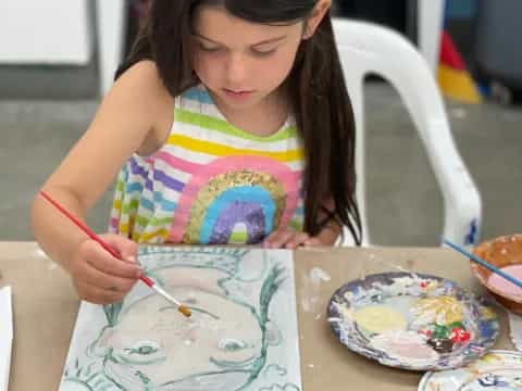 a girl painting on a table