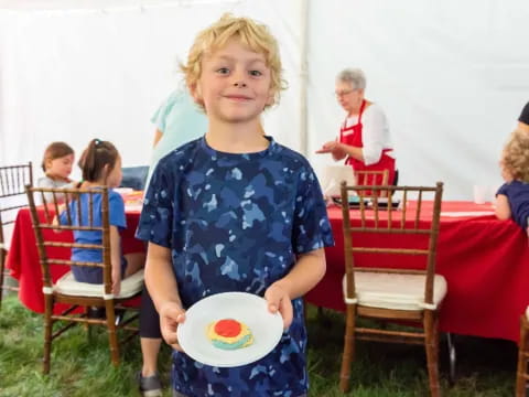 a boy holding a plate