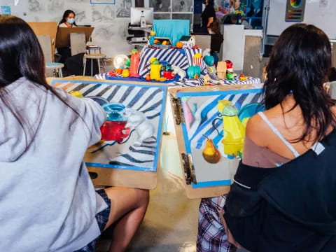 a group of people sitting at a table with toys on it