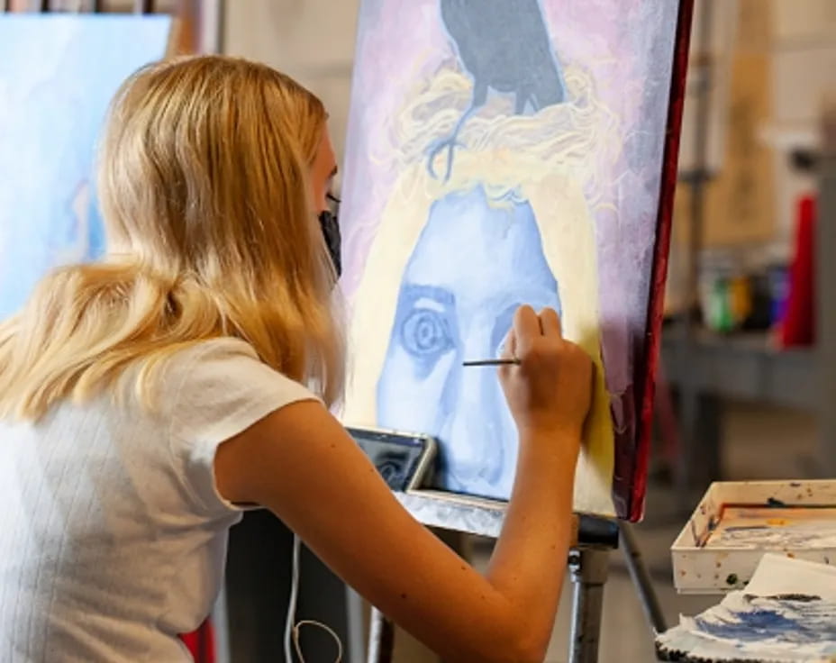 a woman painting a picture