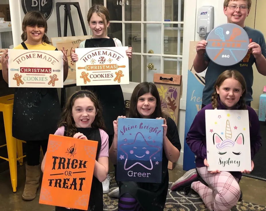 a group of kids holding signs