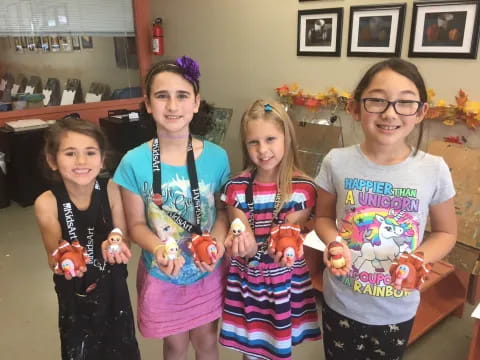 a group of girls holding toys