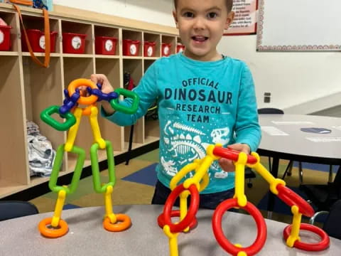 a boy standing next to toys