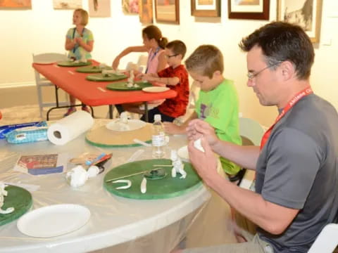 a man and a couple of kids at a table with food