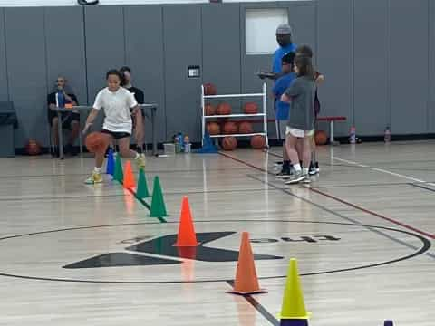 a group of people playing basketball