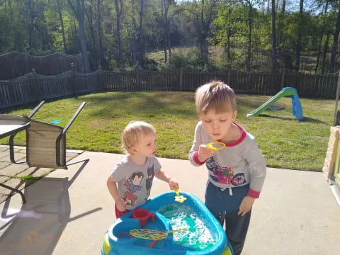 two children playing in a pool