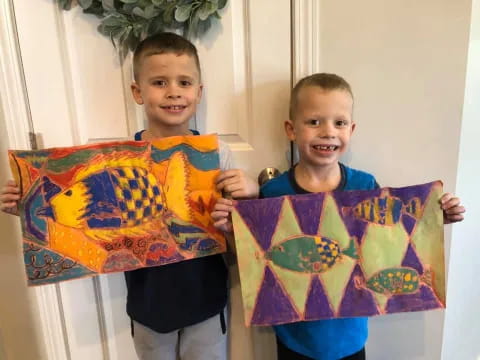 a couple of boys holding up a flag