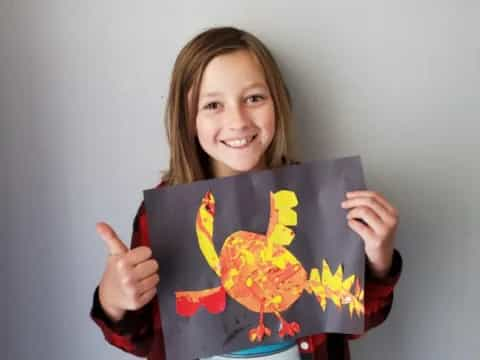 a girl holding a painting