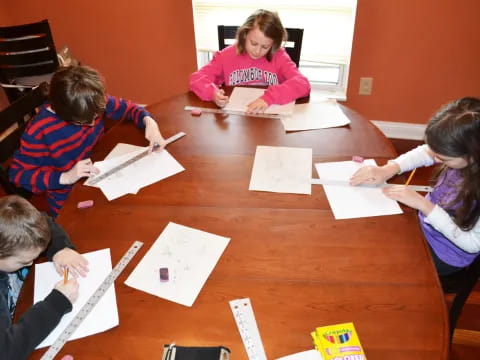 a group of people sitting around a table with papers on it