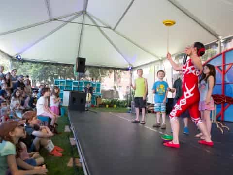 a person holding a frisbee in front of a crowd