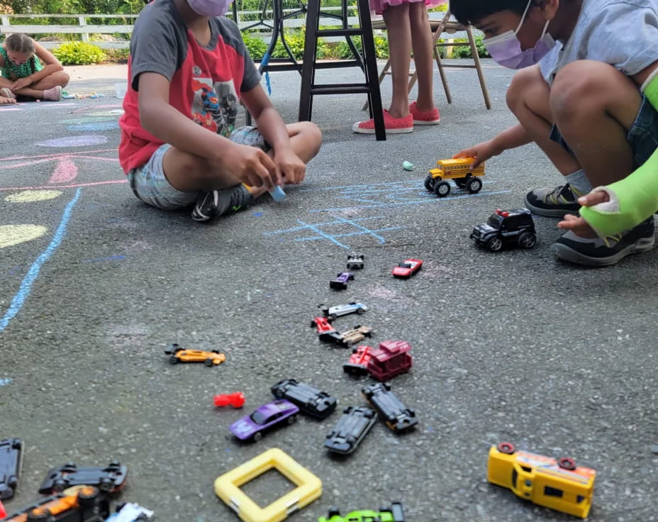 a group of kids playing with toys