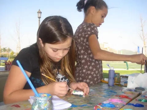 a person painting on a table