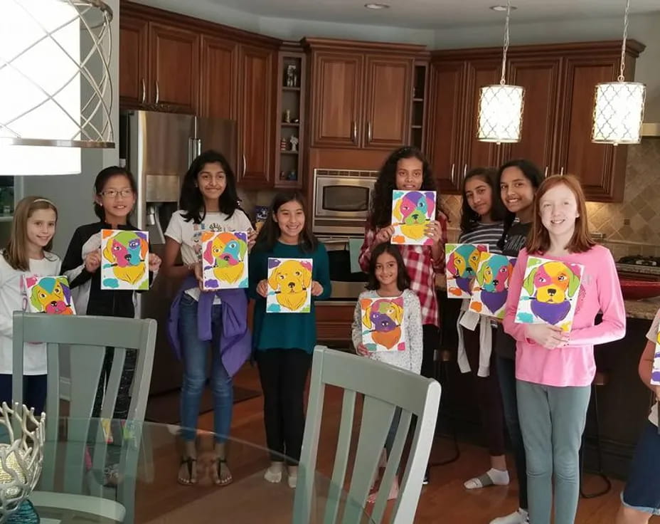 a group of girls holding signs