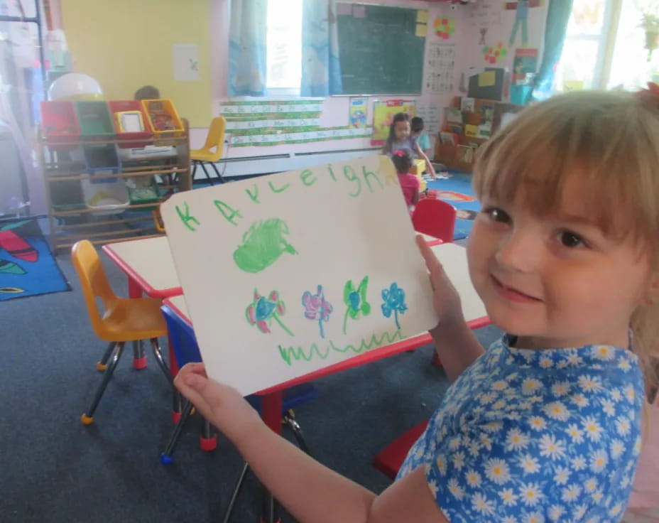 a child holding a drawing