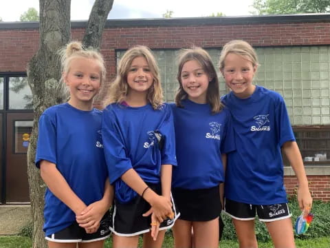 a group of girls in blue shirts