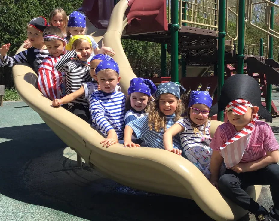 a group of kids sitting on a slide