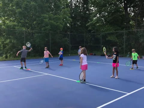 kids playing tennis on a court